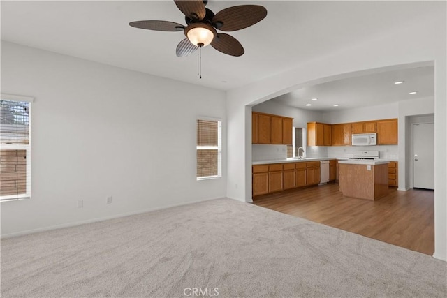 4349 Bethpage Dr, Palmdale, CA 93551 - kitchen featuring white appliances, open floor plan, a sink, light colored carpet, and recessed lighting