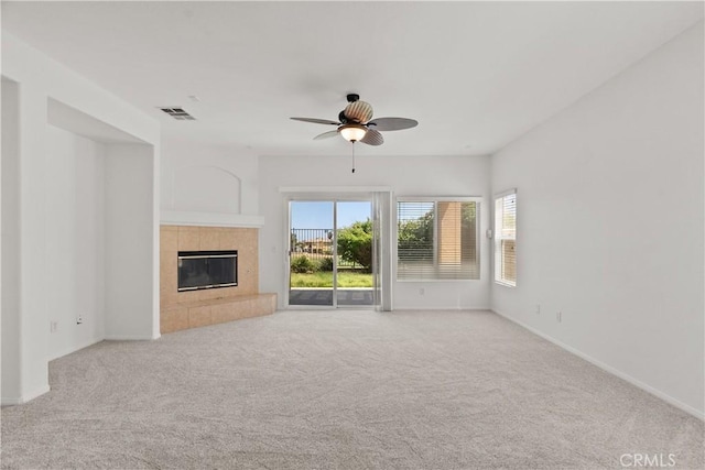 4349 Bethpage Dr, Palmdale, CA 93551 - unfurnished living room with carpet floors, a ceiling fan, a tile fireplace, and baseboards