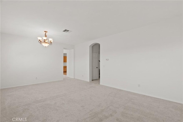 4349 Bethpage Dr, Palmdale, CA 93551 - spare room featuring arched walkways, light carpet, and a chandelier