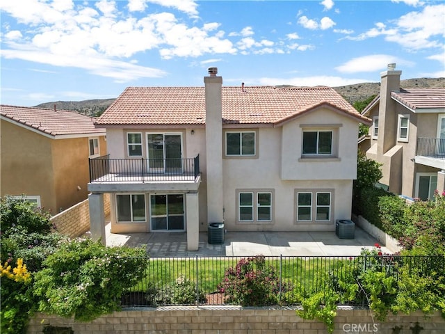 4349 Bethpage Dr, Palmdale, CA 93551 - rear view of property with stucco siding, a balcony, a chimney, a fenced backyard, and a patio