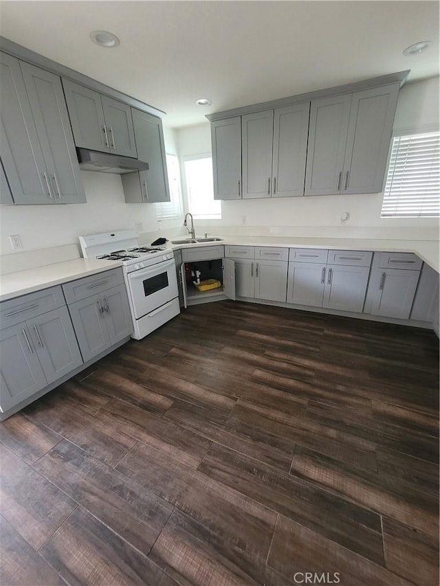 2706 E 57th St, Long Beach, CA 90805 - kitchen featuring white range with gas cooktop, gray cabinetry, under cabinet range hood, a sink, and light countertops