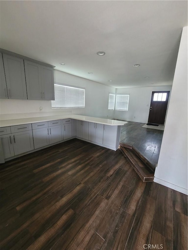 2706 E 57th St, Long Beach, CA 90805 - kitchen featuring gray cabinets, a peninsula, dark wood-type flooring, open floor plan, and light countertops