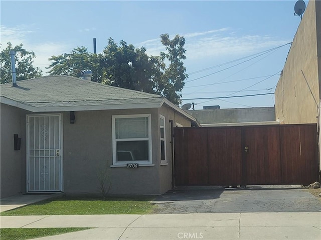 2706 E 57th St, Long Beach, CA 90805 - view of home's exterior with a shingled roof and stucco siding