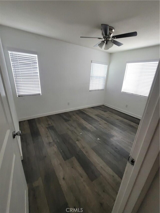 2706 E 57th St, Long Beach, CA 90805 - empty room featuring dark wood finished floors, ceiling fan, and baseboards