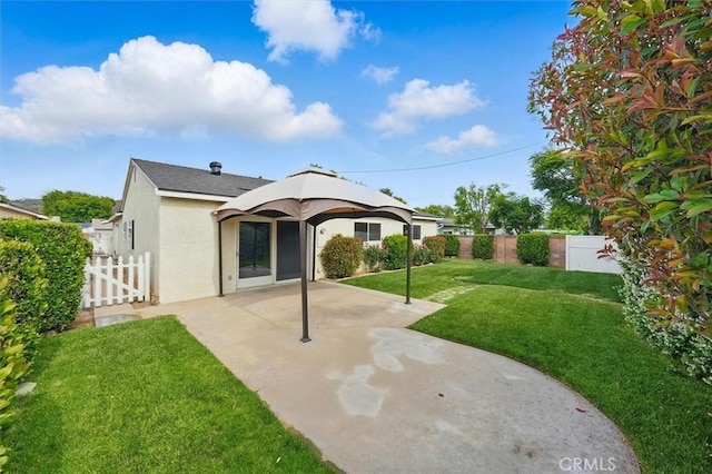 27129 Elias Ave, Saugus, CA 91350 - rear view of house featuring stucco siding and a patio area