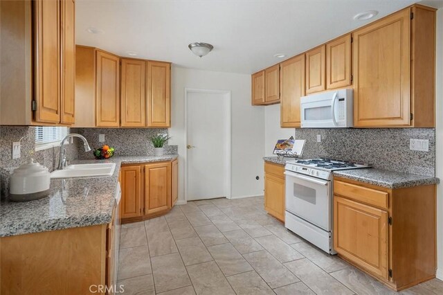 27129 Elias Ave, Saugus, CA 91350 - kitchen with white appliances, a sink, tasteful backsplash, and light tile patterned flooring