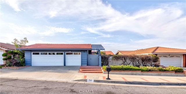 741 W Wedgewood Ln, La Habra, CA 90631 - view of front of property featuring a tile roof, a garage, and driveway