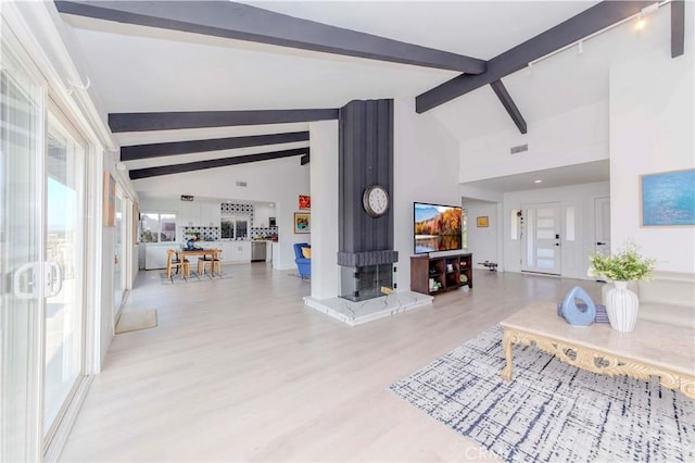 741 W Wedgewood Ln, La Habra, CA 90631 - living room with beam ceiling, light wood finished floors, and high vaulted ceiling