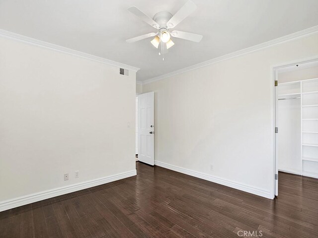 30461 Puerto Vallarta Dr, Laguna Niguel, CA 92677 - unfurnished bedroom featuring crown molding, wood finished floors, baseboards, a walk in closet, and a closet