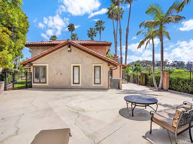 30461 Puerto Vallarta Dr, Laguna Niguel, CA 92677 - rear view of house with stucco siding, a patio, central air condition unit, and a tiled roof