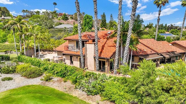 30461 Puerto Vallarta Dr, Laguna Niguel, CA 92677 - back of house featuring a tiled roof, stucco siding, a balcony, and a chimney