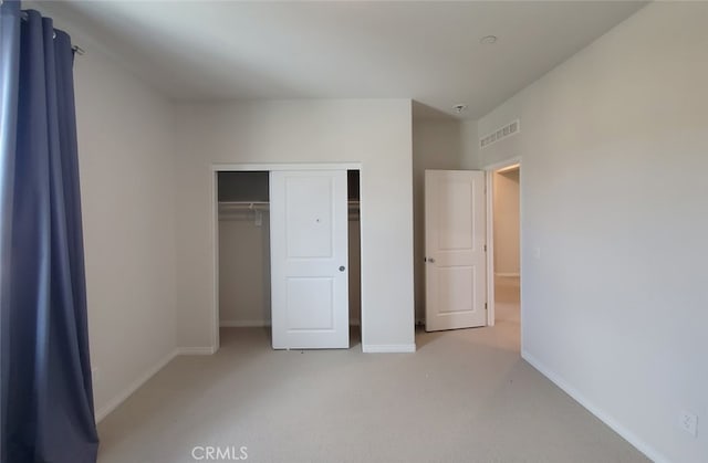 24311 Insignia Dr, Menifee, CA 92584 - unfurnished bedroom featuring light colored carpet, a closet, and baseboards