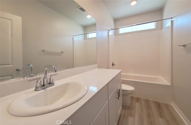24311 Insignia Dr, Menifee, CA 92584 - full bath featuring bathing tub / shower combination, wood finished floors, toilet, and vanity