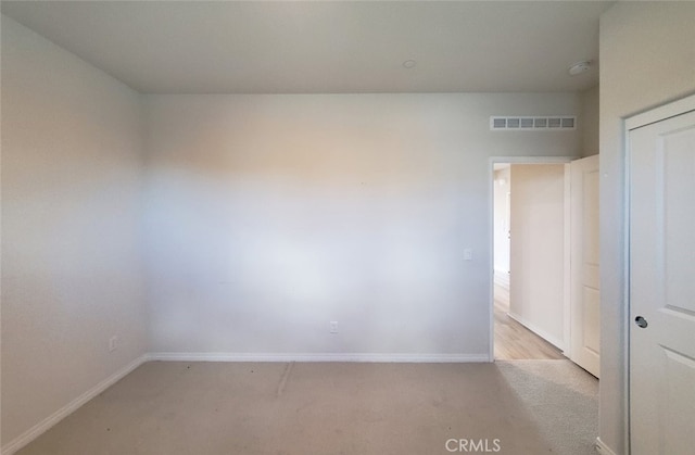 24311 Insignia Dr, Menifee, CA 92584 - spare room featuring light colored carpet, baseboards, and a smoke detector