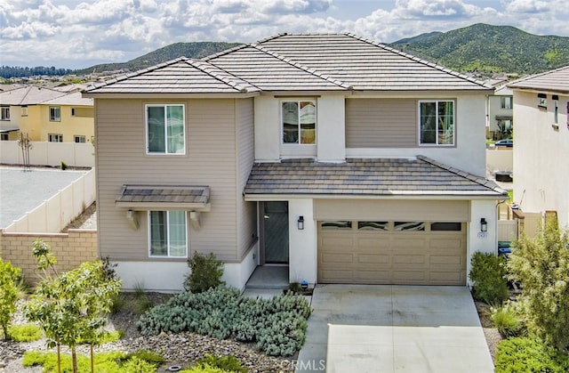 24311 Insignia Dr, Menifee, CA 92584 - traditional-style home featuring concrete driveway, an attached garage, a mountain view, and stucco siding
