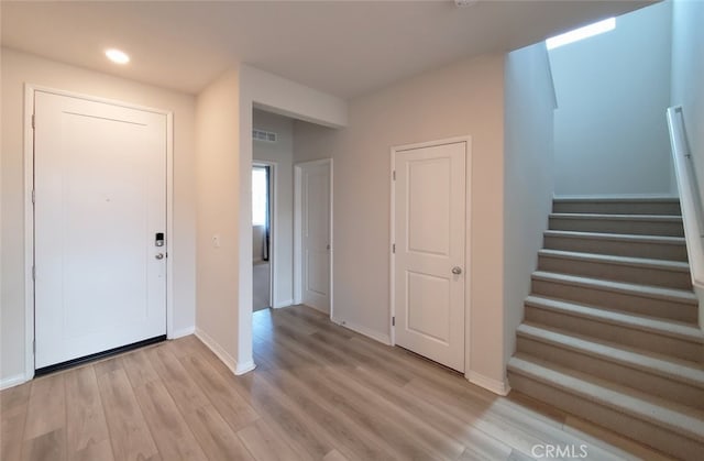 24311 Insignia Dr, Menifee, CA 92584 - foyer entrance with stairway, light wood finished floors, baseboards, and recessed lighting