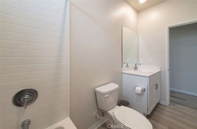 24311 Insignia Dr, Menifee, CA 92584 - bathroom featuring vanity, toilet, wood finished floors, and baseboards