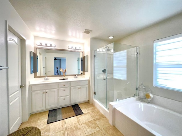 10382 Sparkling Dr Unit 2, Rancho Cucamonga, CA 91730 - bathroom featuring a shower stall, a bath, double vanity, tile patterned floors, and a textured ceiling