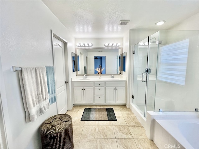 10382 Sparkling Dr Unit 2, Rancho Cucamonga, CA 91730 - bathroom featuring double vanity, a shower stall, a garden tub, a textured ceiling, and tile patterned flooring