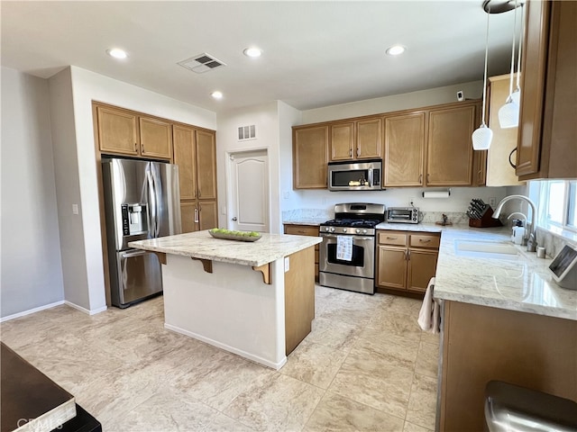 10382 Sparkling Dr Unit 2, Rancho Cucamonga, CA 91730 - kitchen featuring appliances with stainless steel finishes, a center island, a kitchen bar, light stone countertops, and brown cabinets