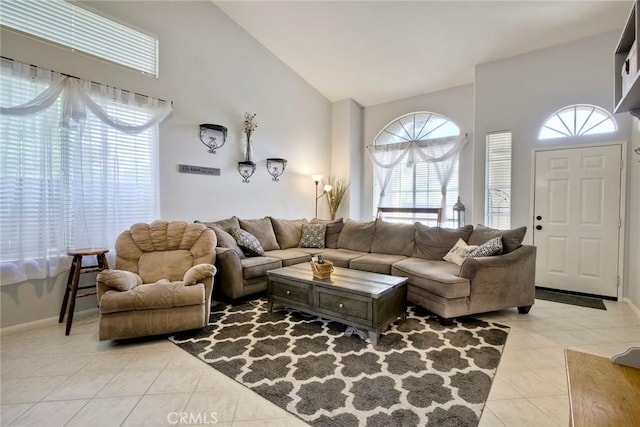 3311 Avocado Vista Ln, Fallbrook, CA 92028 - living area featuring light tile patterned floors, high vaulted ceiling, and baseboards