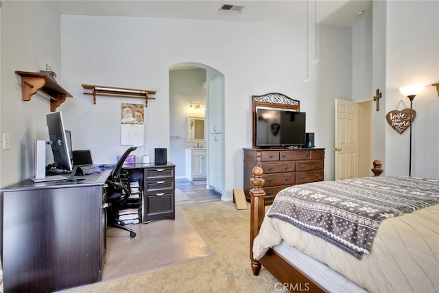 3311 Avocado Vista Ln, Fallbrook, CA 92028 - bedroom with arched walkways, light carpet, an office area, and ensuite bathroom