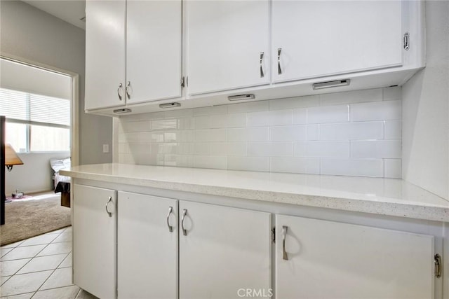 3311 Avocado Vista Ln, Fallbrook, CA 92028 - kitchen with white cabinets, backsplash, light tile patterned flooring, and light stone countertops