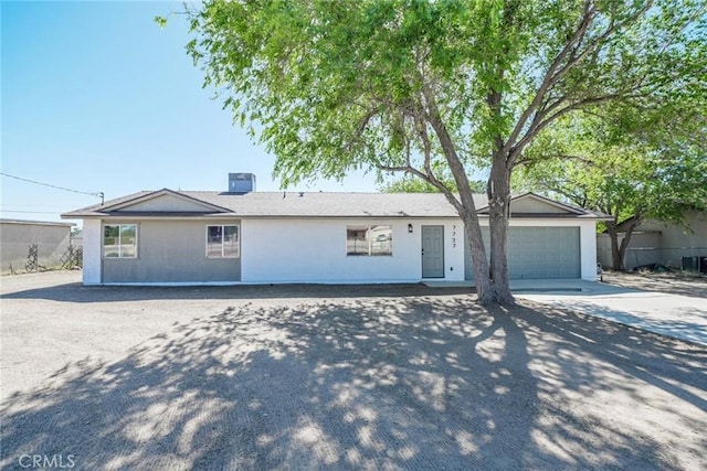 7727 Oakwood Ave, Hesperia, CA 92345 - ranch-style house featuring driveway, a garage, and stucco siding