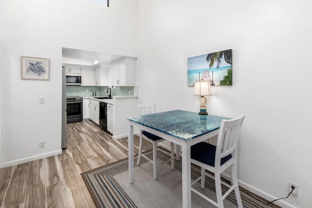 7335 Alicante Rd Unit C, Carlsbad, CA 92009 - dining room with light wood-style floors and baseboards
