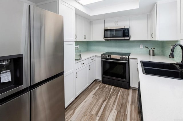 7335 Alicante Rd Unit C, Carlsbad, CA 92009 - kitchen with appliances with stainless steel finishes, a sink, and white cabinetry