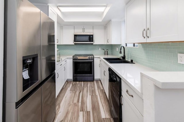 7335 Alicante Rd Unit C, Carlsbad, CA 92009 - kitchen featuring stainless steel appliances, a sink, light countertops, and white cabinetry