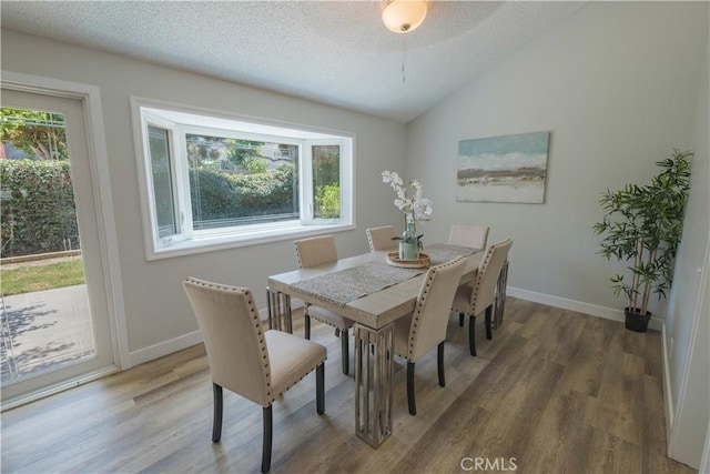 1506 W Sharon Rd, Santa Ana, CA 92706 - dining room with healthy amount of natural light, wood finished floors, lofted ceiling, baseboards, and a textured ceiling