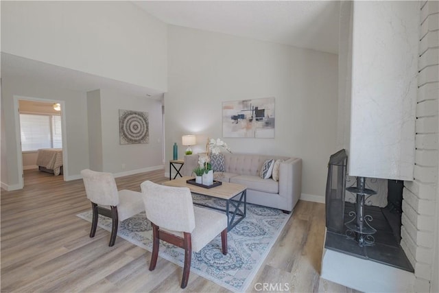 1506 W Sharon Rd, Santa Ana, CA 92706 - living area featuring light wood-style floors, baseboards, and vaulted ceiling