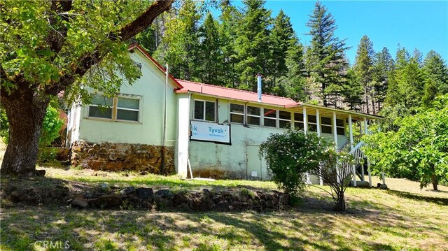 38703 State Highway 96, Klamath River, CA 96086 - view of front facade featuring stucco siding and metal roof