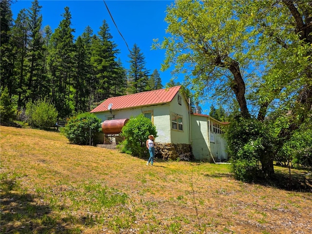 38703 State Highway 96, Klamath River, CA 96086 - view of property exterior with metal roof, heating fuel, a lawn, and stucco siding