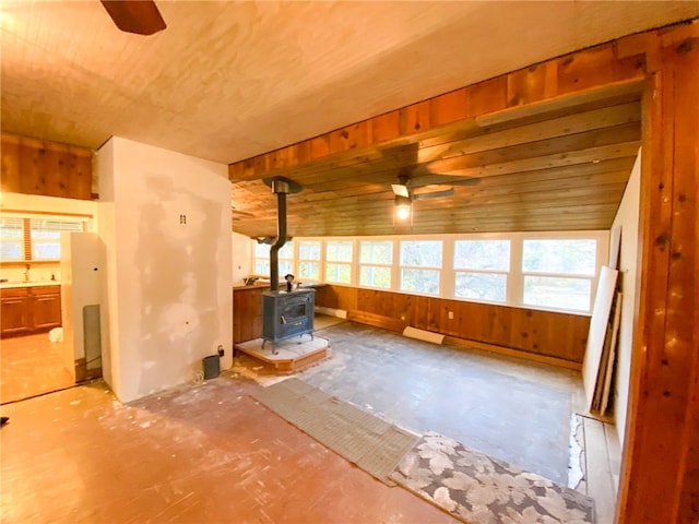 38703 State Highway 96, Klamath River, CA 96086 - unfurnished living room with ceiling fan, a wood stove, wooden ceiling, and wooden walls