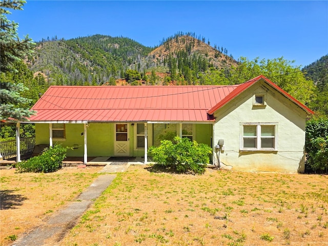 38703 State Highway 96, Klamath River, CA 96086 - view of front of property featuring stucco siding, covered porch, a mountain view, and metal roof