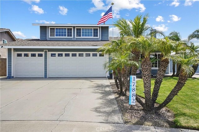 17882 Hallcroft Ln, Huntington Beach, CA 92647 - view of front of property featuring driveway, a front lawn, and roof with shingles