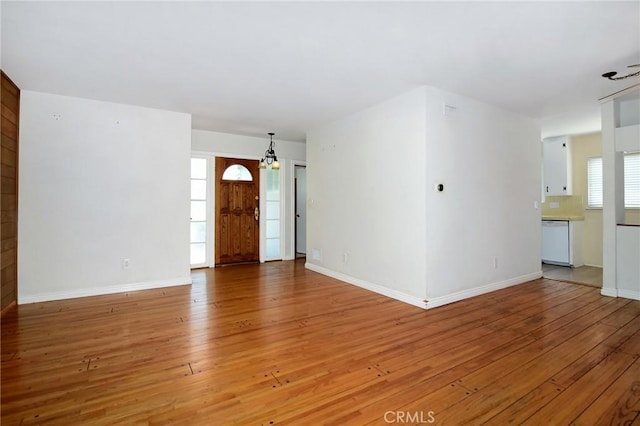 5655 Wish Ave, Encino, CA 91316 - unfurnished living room with light wood-style flooring and baseboards