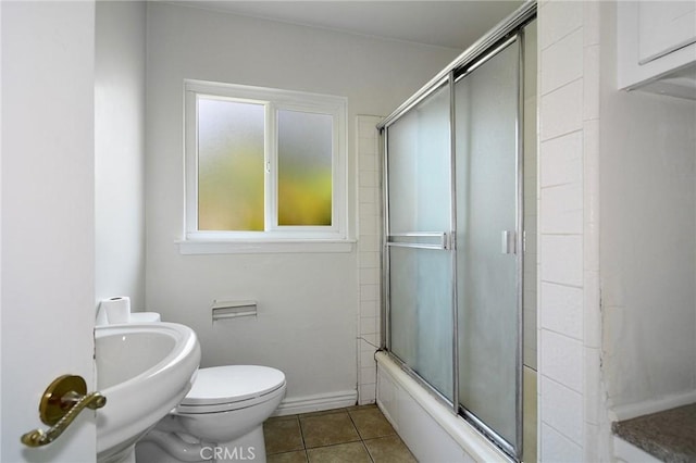 5655 Wish Ave, Encino, CA 91316 - bathroom with tile patterned floors, toilet, enclosed tub / shower combo, a sink, and baseboards