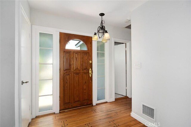 5655 Wish Ave, Encino, CA 91316 - foyer entrance with light wood-type flooring and a chandelier