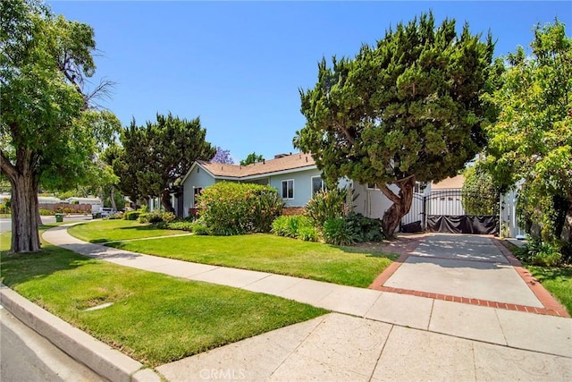 5655 Wish Ave, Encino, CA 91316 - obstructed view of property with a front lawn, a gate, and concrete driveway