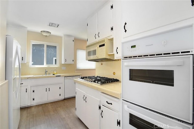 5655 Wish Ave, Encino, CA 91316 - kitchen with tile countertops, white appliances, a sink, and white cabinetry
