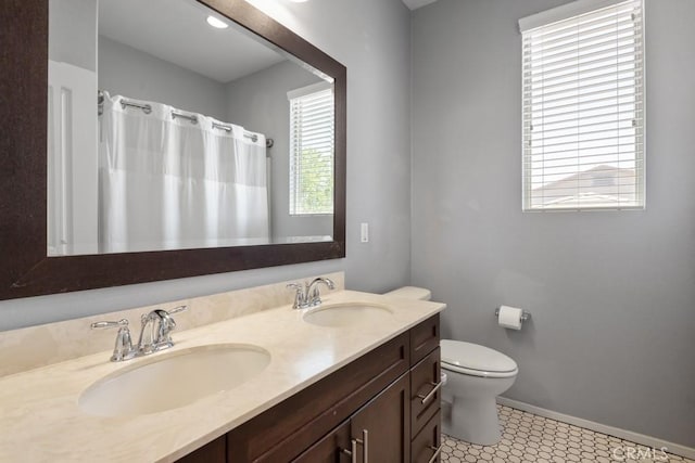 29463 Bouris Dr, Menifee, CA 92584 - bathroom with double vanity, toilet, baseboards, and a shower with shower curtain