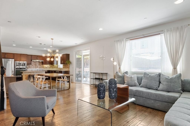 29463 Bouris Dr, Menifee, CA 92584 - living area featuring light wood-style floors, recessed lighting, and a chandelier