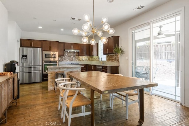 29463 Bouris Dr, Menifee, CA 92584 - dining area featuring dark wood-style flooring, recessed lighting, a chandelier, and a ceiling fan