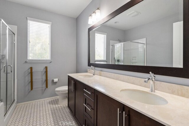 29463 Bouris Dr, Menifee, CA 92584 - full bathroom featuring healthy amount of natural light, a shower stall, double vanity, and toilet