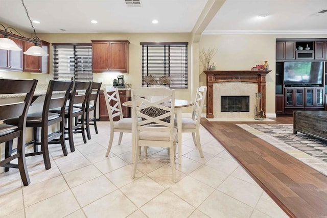1327 Silver Hawk Way, Chula Vista, CA 91915 - dining area featuring recessed lighting, crown molding, a fireplace, and light tile patterned floors