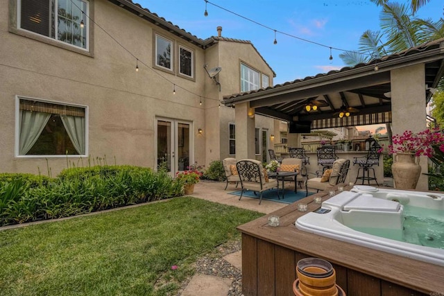 1327 Silver Hawk Way, Chula Vista, CA 91915 - back of property featuring a hot tub, exterior bar, ceiling fan, stucco siding, and a patio area