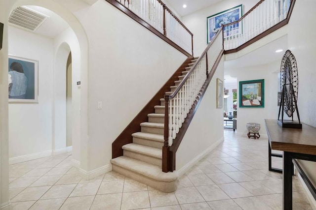 1327 Silver Hawk Way, Chula Vista, CA 91915 - stairs featuring tile patterned floors, arched walkways, recessed lighting, and a high ceiling